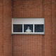 A health worker wearing a protective suit stands at a window in the isolation ward of the Carlos III hospital in Madrid.